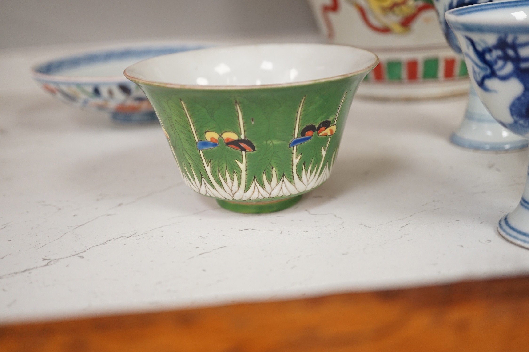 A Chinese wucai vase, two Imari bowls, a pair of Chinese blue and white dragon stem cups, Xuande marks, a Chinese blue and white dish, depicting a scholar on horseback, Xuande mark, a small green Chinese bowl, painted wi